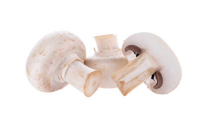Close-up of three white button fungi, one sliced, against a dark backdrop