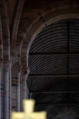 Historic Romanesque architecture with massive columns and ribbed vaults at Mont Saint-Michel. Romanesque stone arches and vaulted wooden ceiling inside the Abbey of Mont Saint-Michel. 