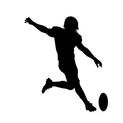 Silhouette of an american football player kicking the ball with power
