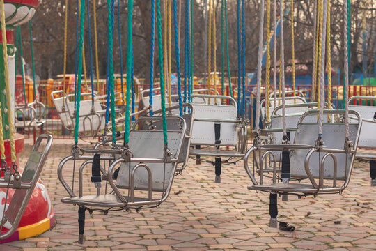 Empty swing seats in amusement par