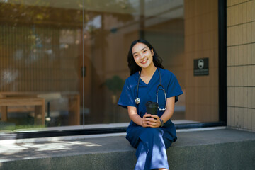 Asian nurse enjoying coffee break during work