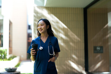 Asian female nurse smiling taking coffee break
