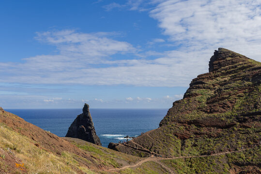 Scenic hiking path through the rocky landscape of Sao Lourenco Point in Madeira, showing layered cliffs, vivid textures, and deep blue ocean stretching beyond