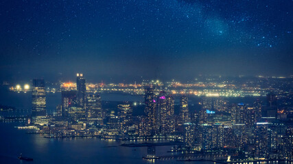 Beautiful night aerial panorama of Jersey City skyline with city lights and waterfront view on a...