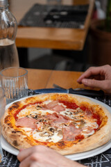 Italian style pizza on a plate at fine dining restaurant with warm and inviting presentation