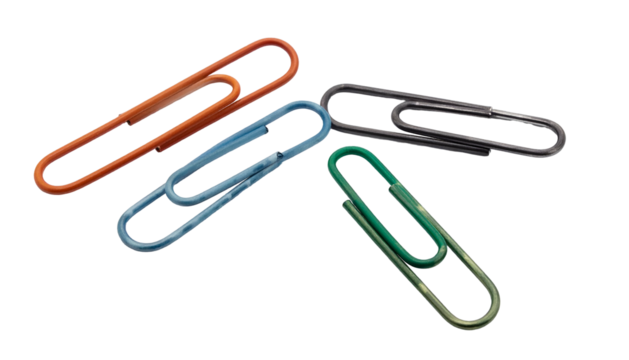 Four colorful paperclips of varied shades against a black background, scattered, close-up view