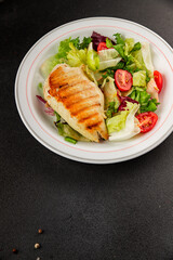 Grilled chicken breast salad chicken breast tomato, green leaf lettuce, salad mix snack vegetablestasty snack fresh gourmet food background on the table rustic top view copy space keto and paleo diet