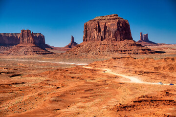 Scenic view of Monument Valley with iconic sandstone formations and arid summer terrain