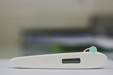 Digital thermometer test kit with display on white surface