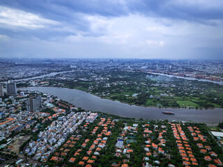 A city with a river running through it. The river is surrounded by houses and buildings. There is a boat on the river