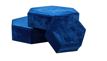 Three stacked hexagonal boxes with a plush, velvety texture and a rich, vibrant blue hue, set against a dark, contrasting backdrop