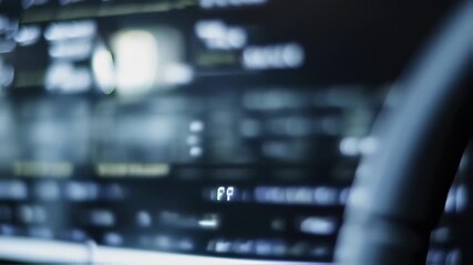 A dimly lit control panel with blurry displays and digital readouts, soft focus - Powered by Adobe