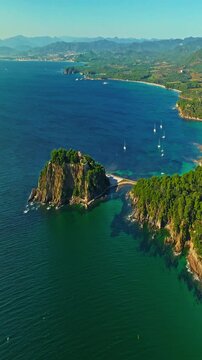  Aerial view of Fort Bregancon sunset aerial view from the mediterranean sea. A yacht is anchored near the fortress
