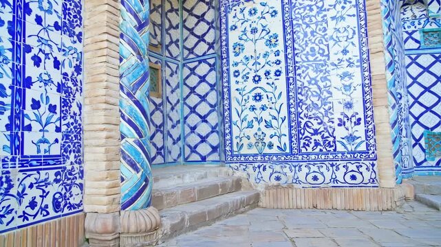 Architectural detail of a building with intricate blue and white tile patterns and a spiral column