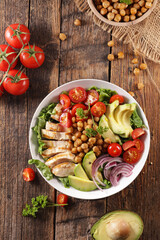 healthy poke bowl with chicken, chickpea, avocado and tomatoes