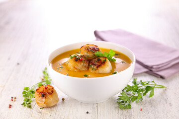 gourmet bowl of soup with roasted scallop