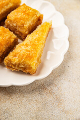 Baklava with pistachios and almonds dessert oriental sweets natural product tasty snack fresh delicious gourmet food background on the table rustic top view copy space