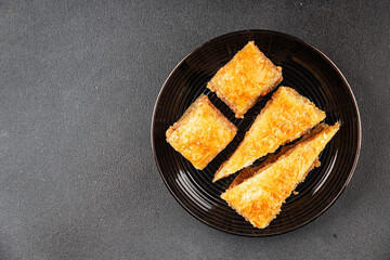 Baklava with pistachios and almonds dessert oriental sweets natural product tasty snack fresh delicious gourmet food background on the table rustic top view copy space