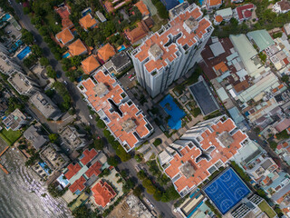 City view with a blue pool in the middle. The buildings are tall and have red roofs