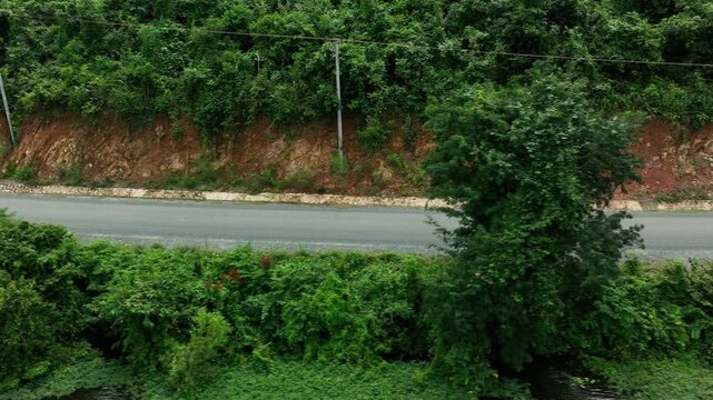 Traditional Asian Tuk Tuk is riding through the forest