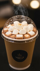 Hot cocoa takeaway cup with marshmallows and steam visible  