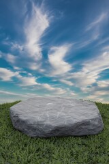 Stone podium on green grass with cloudy sky background