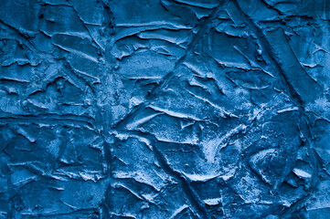 blue background, in the photo the texture of a gray wall with various lines, strokes and cracks