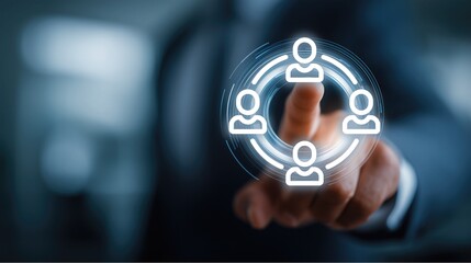 Businessman&rsquo;s finger touches glowing team icon (circular group of people symbols) against professional background, embodying collaboration, social connection and group unity in modern business setting