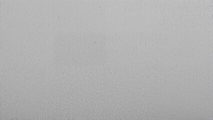 Gray textured background or surface with minimal features.