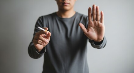 Stop smoking gesture concept with hand and cigarette addiction issues