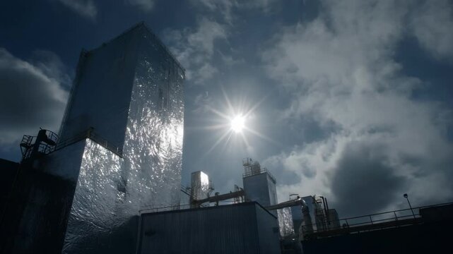 Medium shot of UVresistant solar reflective aluminum cladding protecting an industrial structure emphasizing durability and energy efficiency under harsh sun exposure