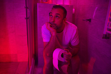 Man with urge to go to the toilet at home.