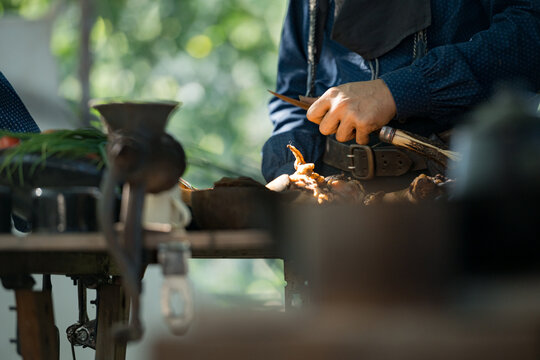 Cowboys gather around a chuck wagon preparing fresh ingredients for cooking
