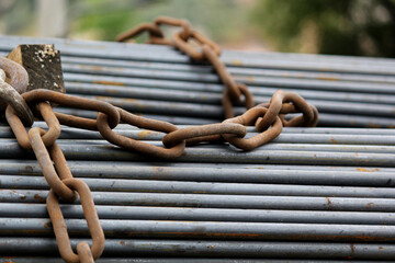 Heavy Steel Rods Secured with Chain for Construction Transport Safety