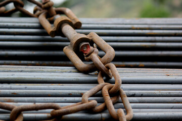 Heavy Steel Rods Secured with Chain for Construction Transport Safety