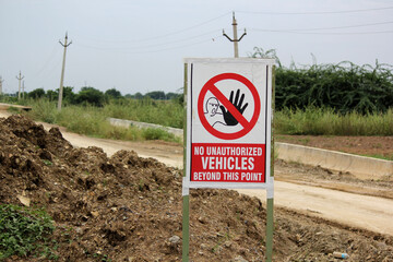 Unauthorized Vehicles Prohibited Sign on Rural Dirt Road