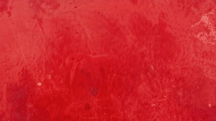 Naklejka premium Red textured surface with a slightly worn and uneven appearance.