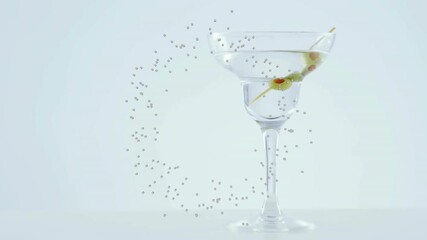 Particle arc arising left starting clockwise ring orbiting martini glass bending light around olive - Powered by Adobe