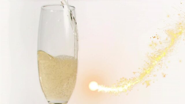 Champagne flute receiving pour, comet trail sweeping around glass, releasing sparkles creating glow