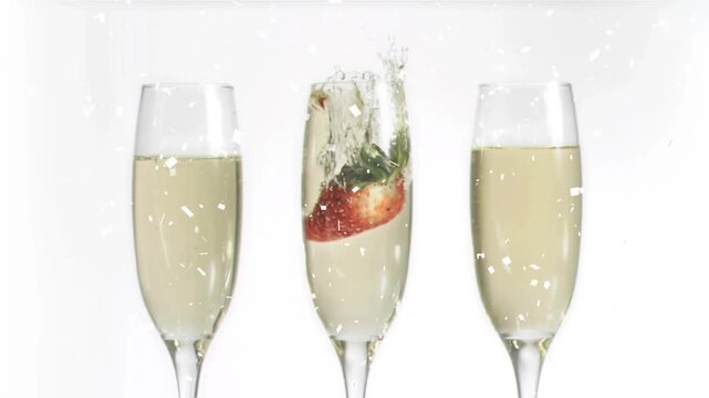 Center champagne flute receiving strawberry drop, sending tall splash outward to showcase beverage