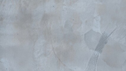 Obraz premium A damaged concrete surface with cracks and patches showing wear and tear.