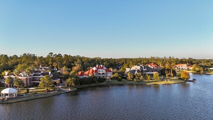 Aerial view of large mansion houses with swimming pool,  in affluent neighborhood  by Woodlands lake, Houston, Texas, expensive suburban homes surrounding by lush green trees, USA
