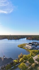 Aerial view of large mansion houses with swimming pool,  in affluent neighborhood  by Woodlands lake, Houston, Texas, expensive suburban homes surrounding by lush green trees, USA