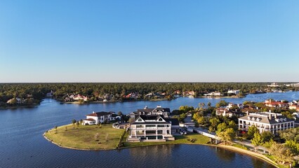 Aerial view of large mansion houses with swimming pool,  in affluent neighborhood  by Woodlands lake, Houston, Texas, expensive suburban homes surrounding by lush green trees, USA
