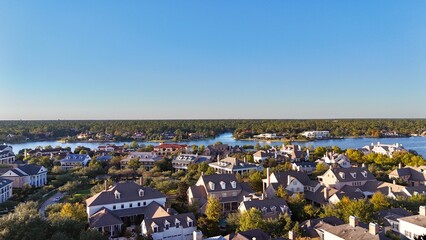 Aerial view of large mansion houses with swimming pool,  in affluent neighborhood  by Woodlands lake, Houston, Texas, expensive suburban homes surrounding by lush green trees, USA