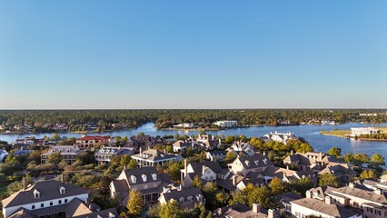 Aerial view of large mansion houses with swimming pool,  in affluent neighborhood  by Woodlands lake, Houston, Texas, expensive suburban homes surrounding by lush green trees, USA