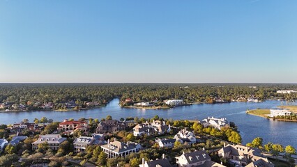 Aerial view of large mansion houses with swimming pool,  in affluent neighborhood  by Woodlands lake, Houston, Texas, expensive suburban homes surrounding by lush green trees, USA