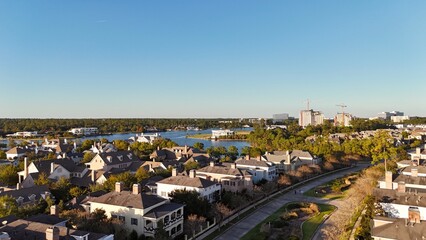 Aerial view of large mansion houses with swimming pool,  in affluent neighborhood  by Woodlands lake, Houston, Texas, expensive suburban homes surrounding by lush green trees, USA