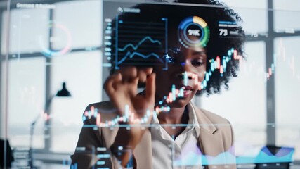 African American Businesswoman Analyzing Financial Data on Transparent Screen - Powered by Adobe