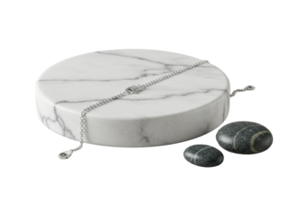 Macro shot: polished sterling silver chain bracelet draped on a white Carrara marble coaster with a dark river stone, seamless transparent background. Concept of refined elegance